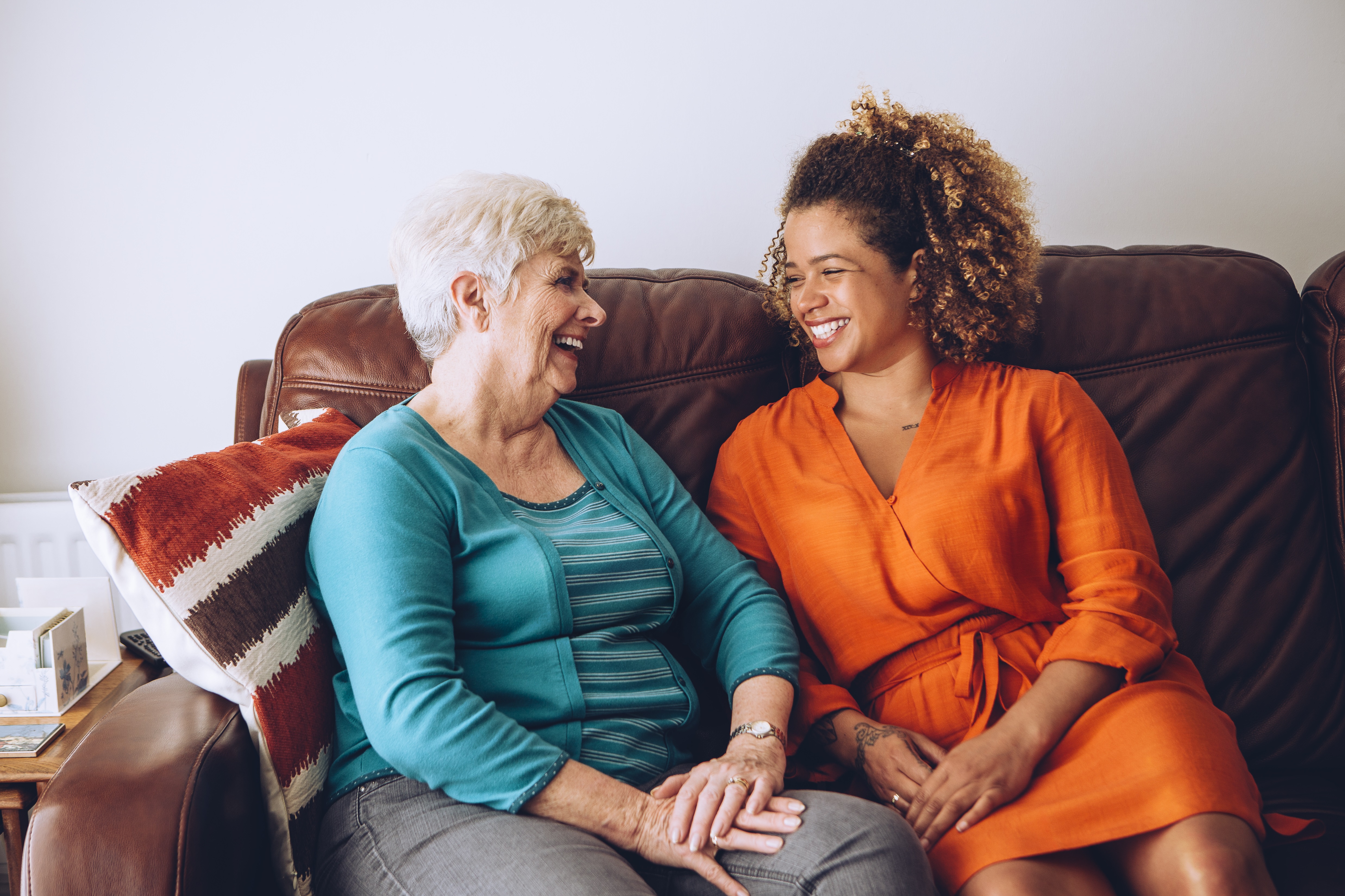 Older and younger women smiling at each other