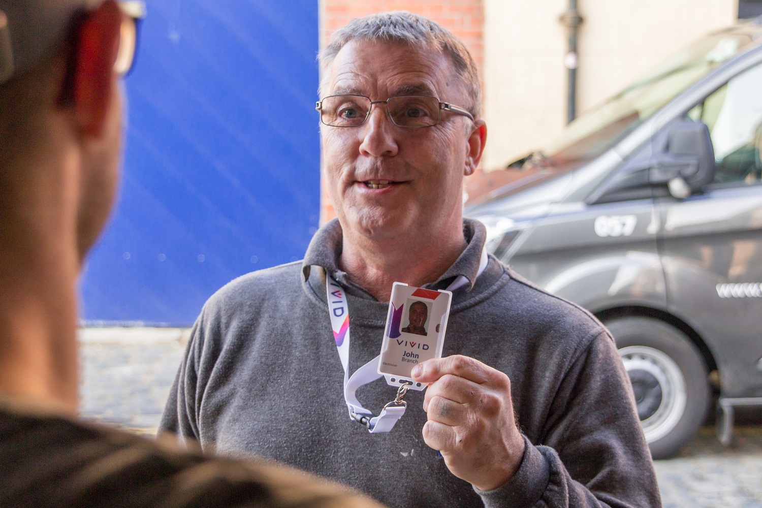 Trade staff John Branch holding up VIVID badge