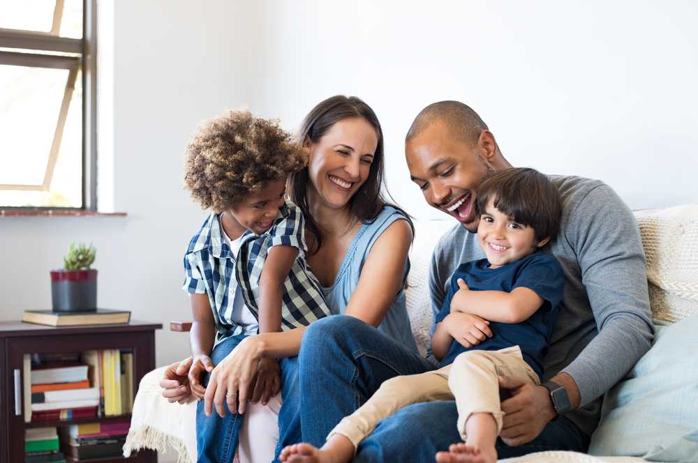 Family hugging on sofa