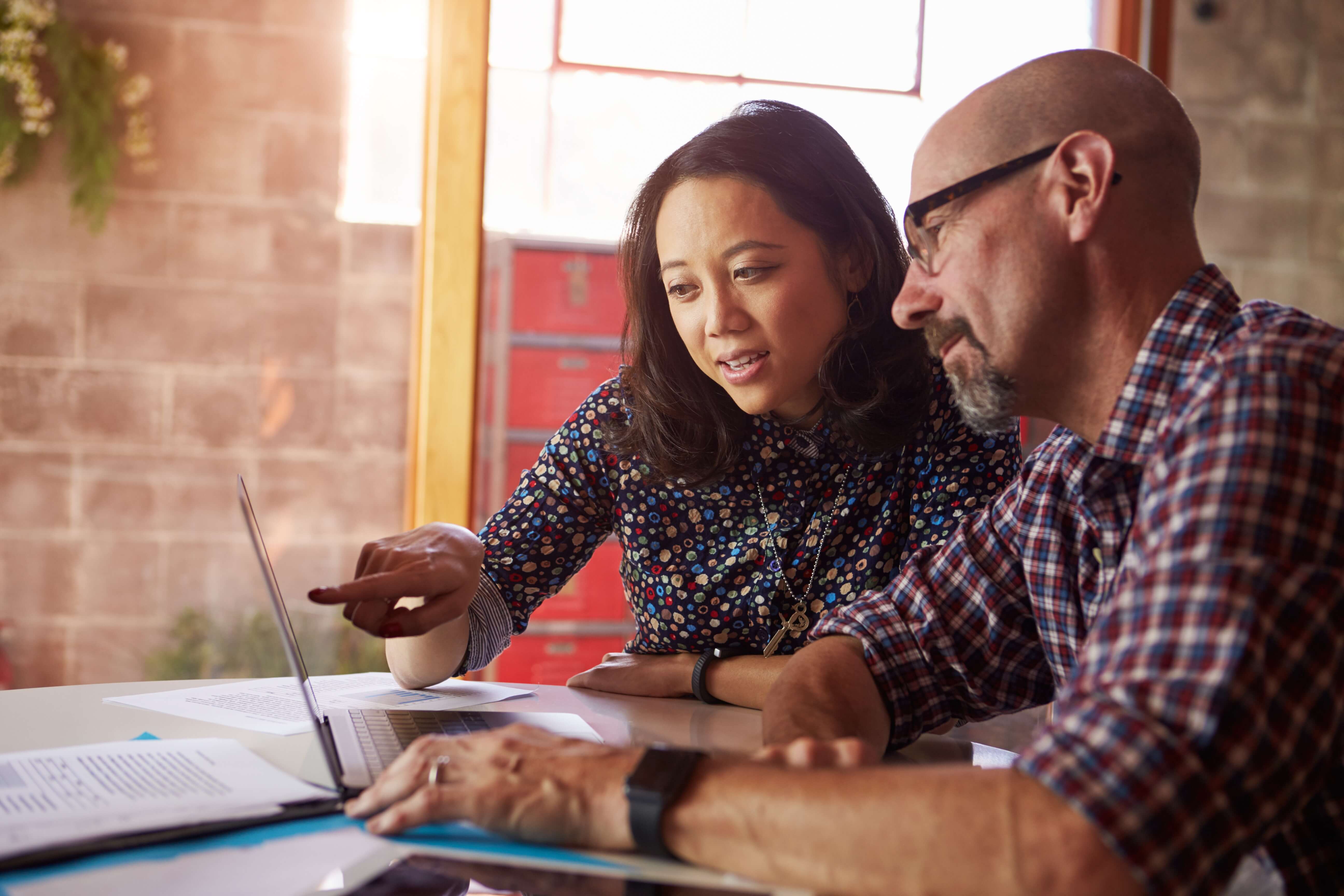 Man and woman looking at laptop
